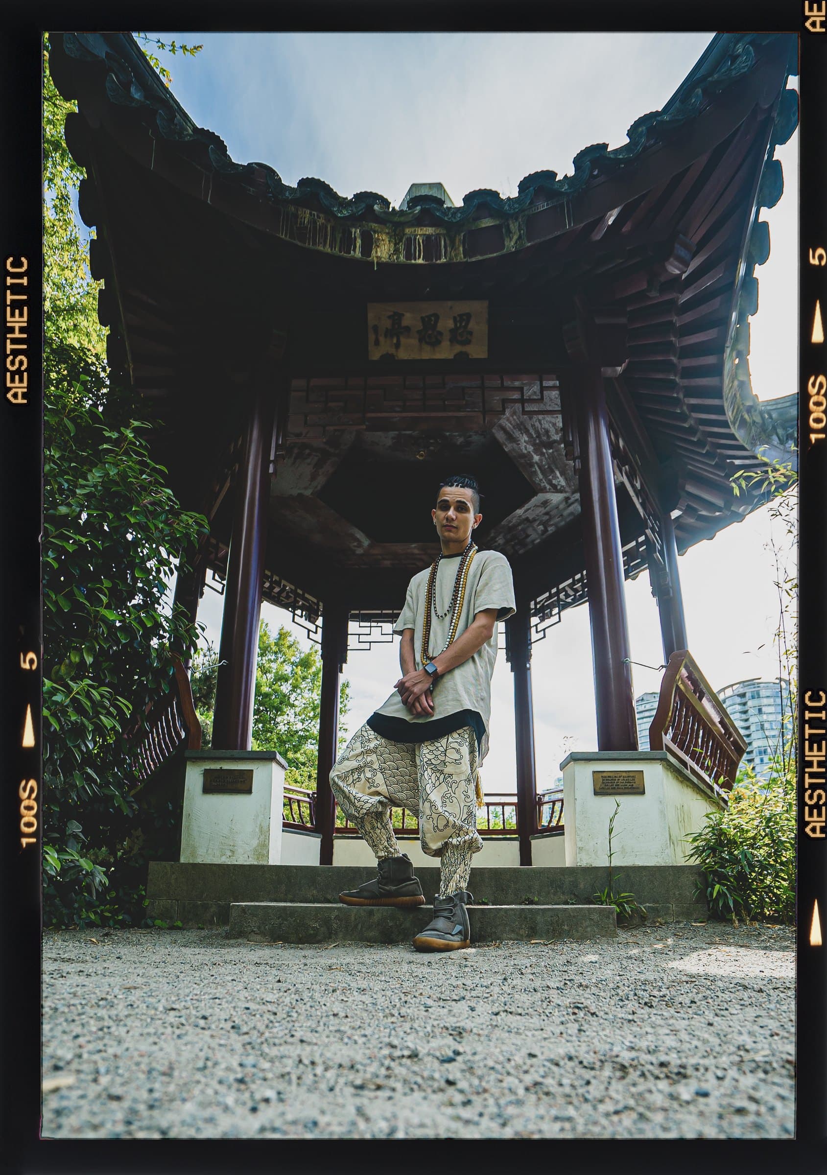Bdice standing in a Chinese garden pavilion, on film